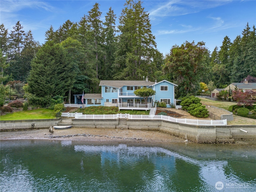 Gig Harbor waterfront gem with 100 ft of shoreline, dock, buoys, and expansive bay views.