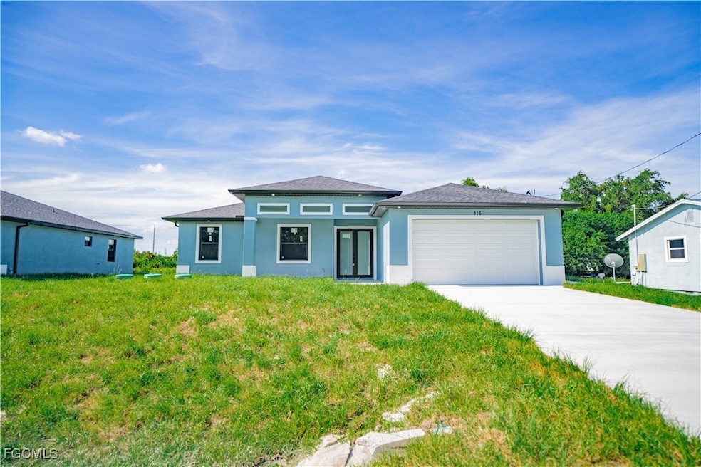 Prairie-style house featuring concrete driveway, an attached garage, stucco siding, and a front lawn
