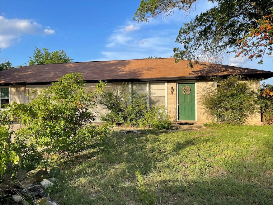 Single story home featuring brick siding, a front