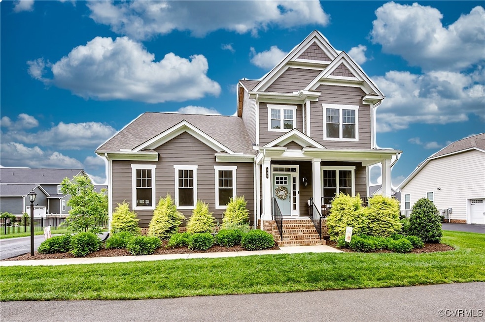 Craftsman-style home with a front yard, a shingled