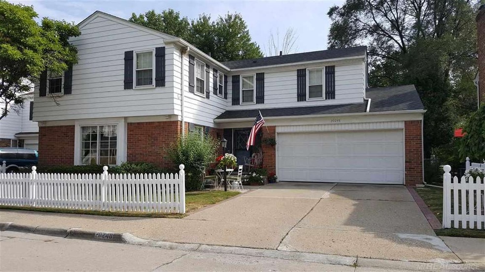 Notice the white picket fence and 2-car garage