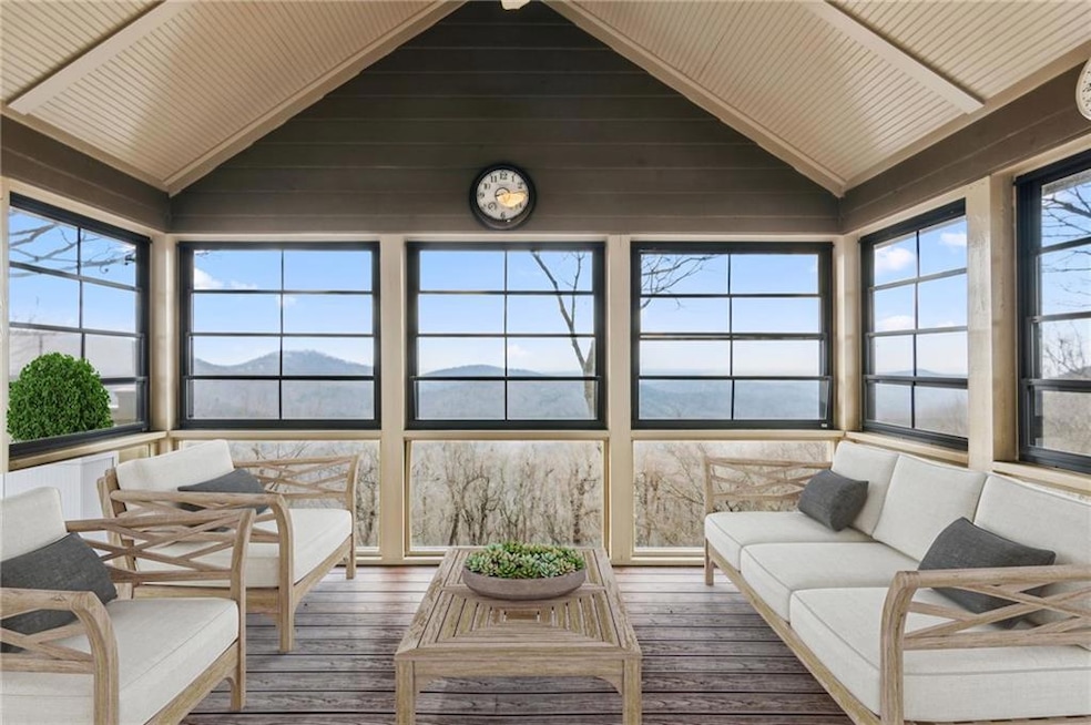 Sunroom / solarium with lofted ceiling and hardwood / wood-style flooring