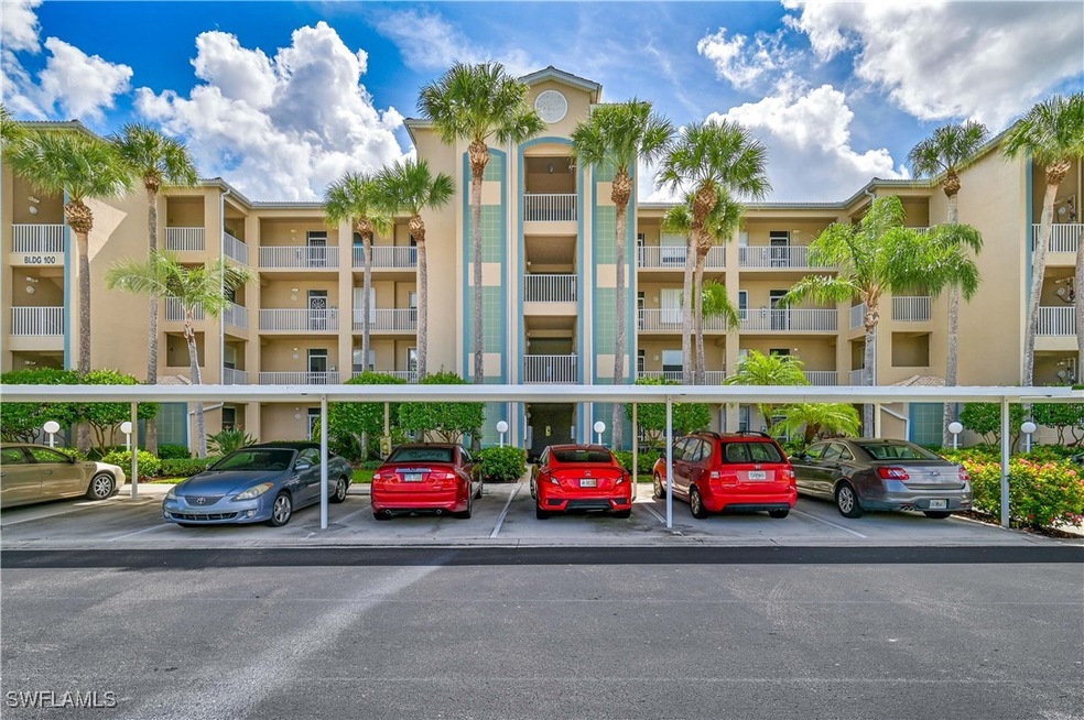 View of building exterior with covered parking