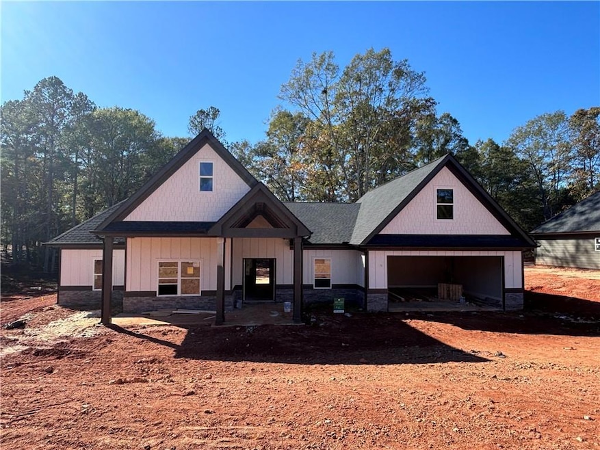 View of front of home with a garage and stone sidi