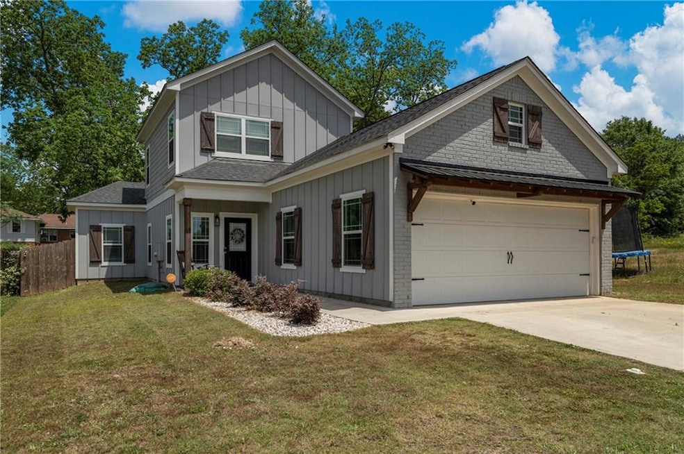 Craftsman-style house featuring roof with shingles