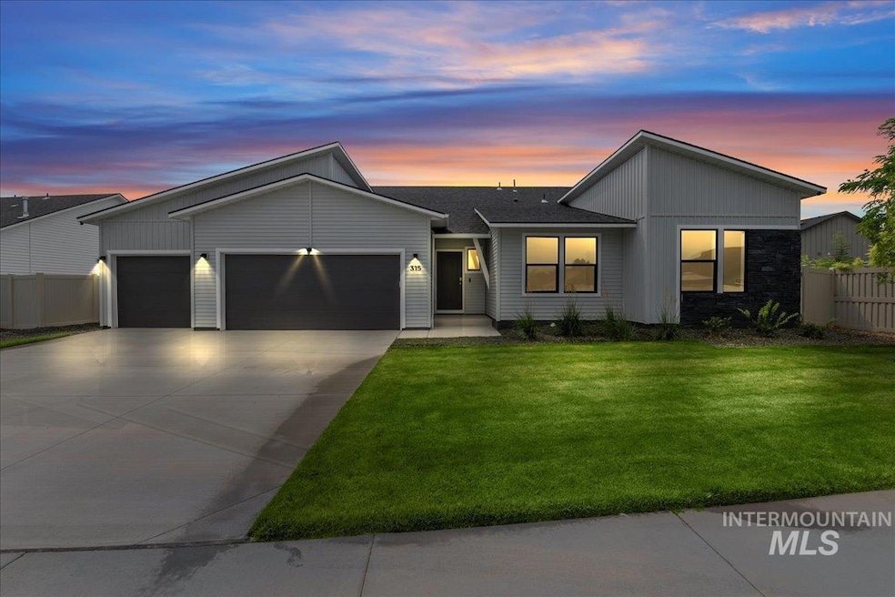 View of front of home featuring an attached garage, driveway, and board and batten siding