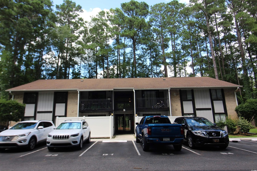 View of property featuring uncovered parking