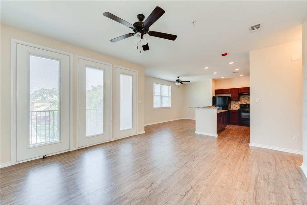 Unfurnished living room featuring ceiling fan and