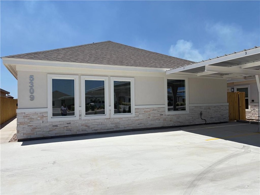 Back of house with stone siding, roof with shingles, covered parking, and stucco siding