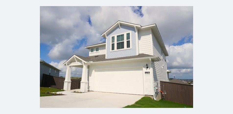 View of front facade with driveway and a garage