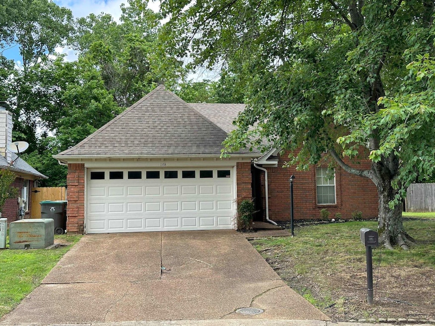 View of front of property with roof with shingles, concrete driveway, a garage, and brick siding