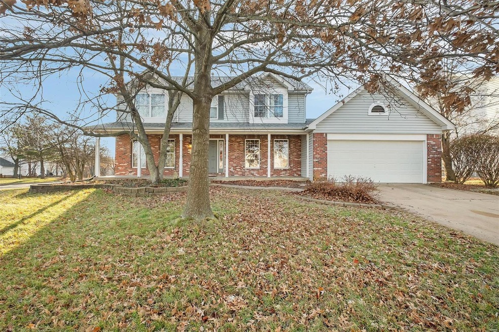 Brick and vinyl siding elevation on a level, fence