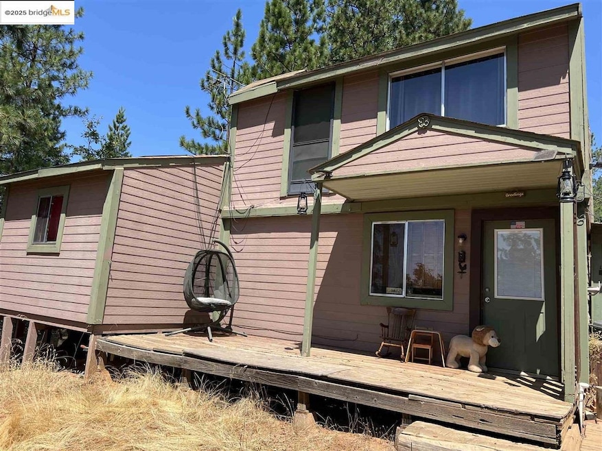 Rear view of property featuring a wooden deck