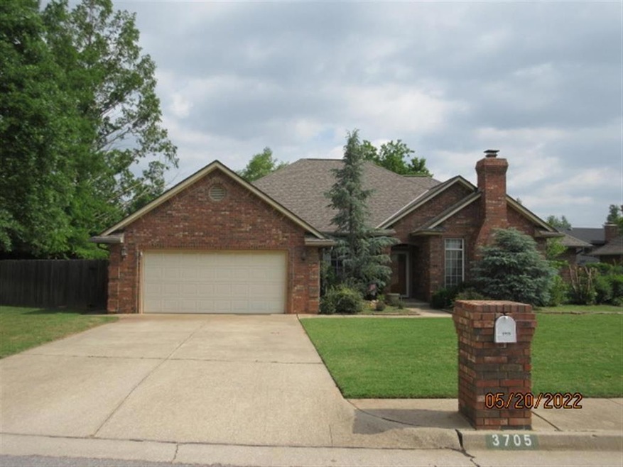View of front of home with a front lawn and a gara