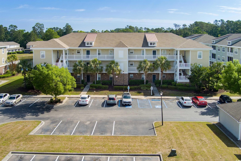 View of property with uncovered parking and a resi