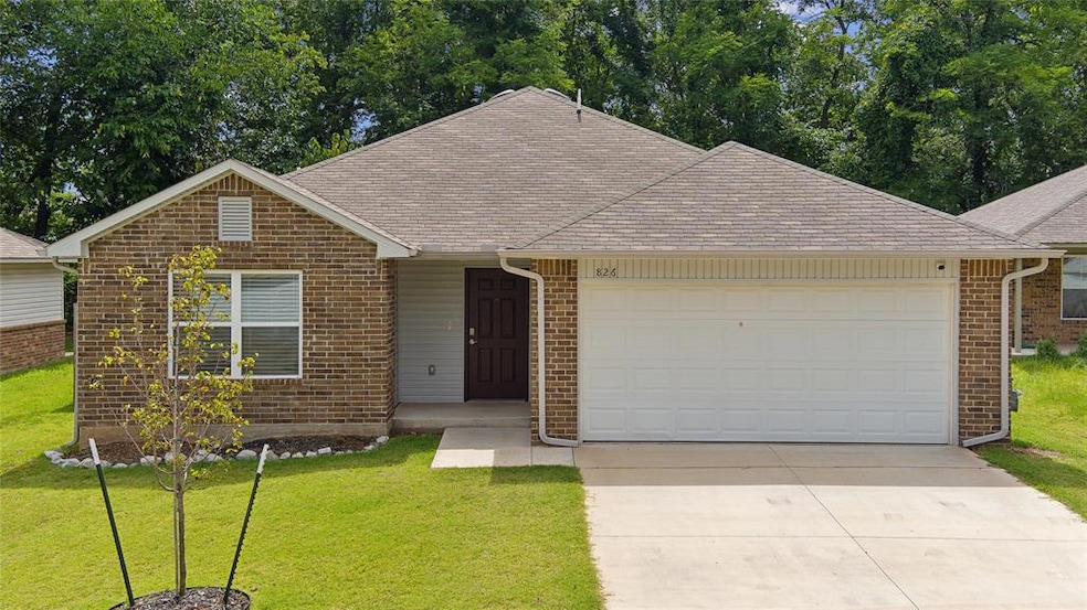 View of front of house with a front yard and a gar