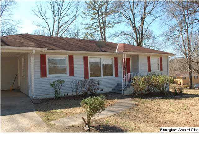 Front of the house with a one car carport that has