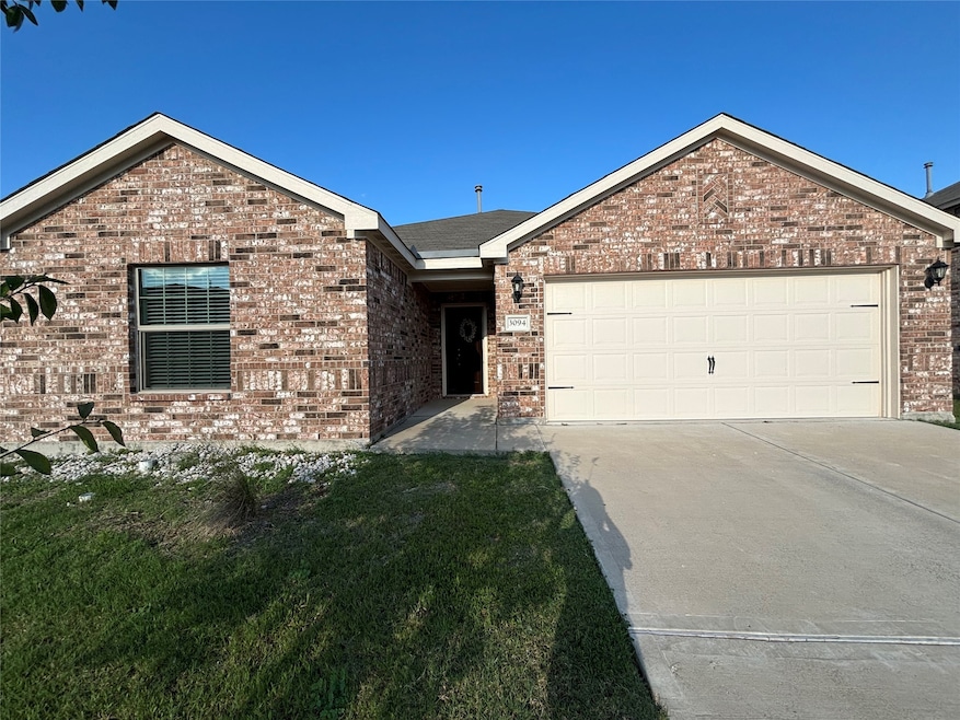Single story home with brick siding, driveway, a garage, and a front yard