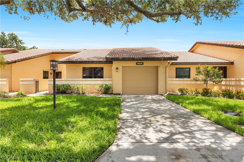 Mediterranean / spanish-style house with stucco siding, an attached garage, concrete driveway, and a tiled roof