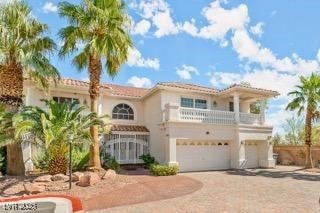 Mediterranean / spanish-style house featuring a ga
