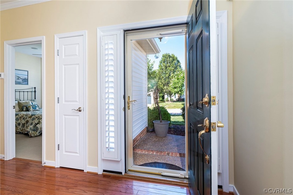 Entrance foyer featuring hardwood / wood-style flo