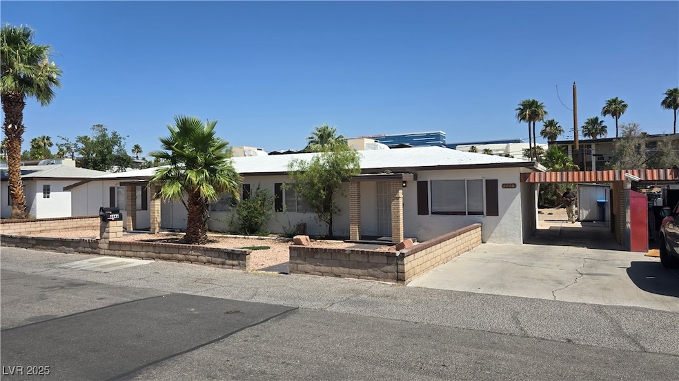 View of front of property with driveway and stucco
