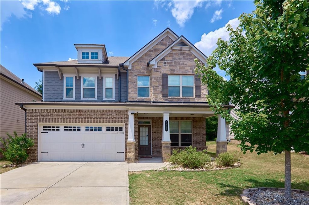 Craftsman-style home with a garage, a porch, and a