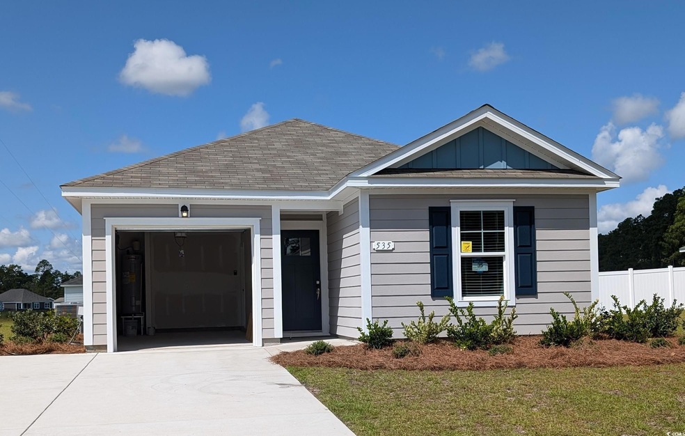 View of front facade with a front lawn and a garag