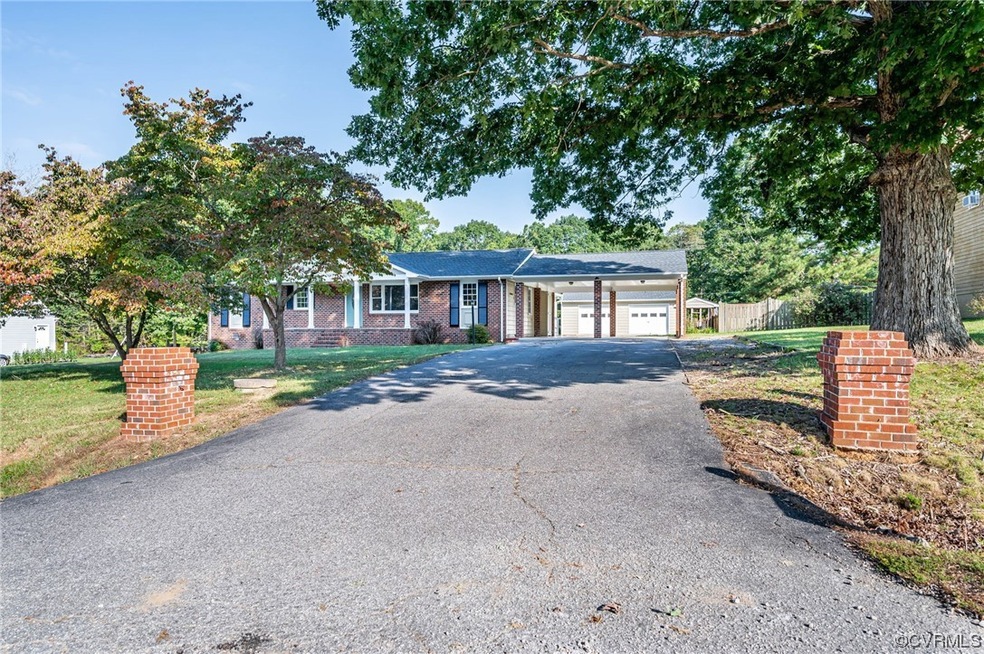 Single story home featuring a garage and a front y