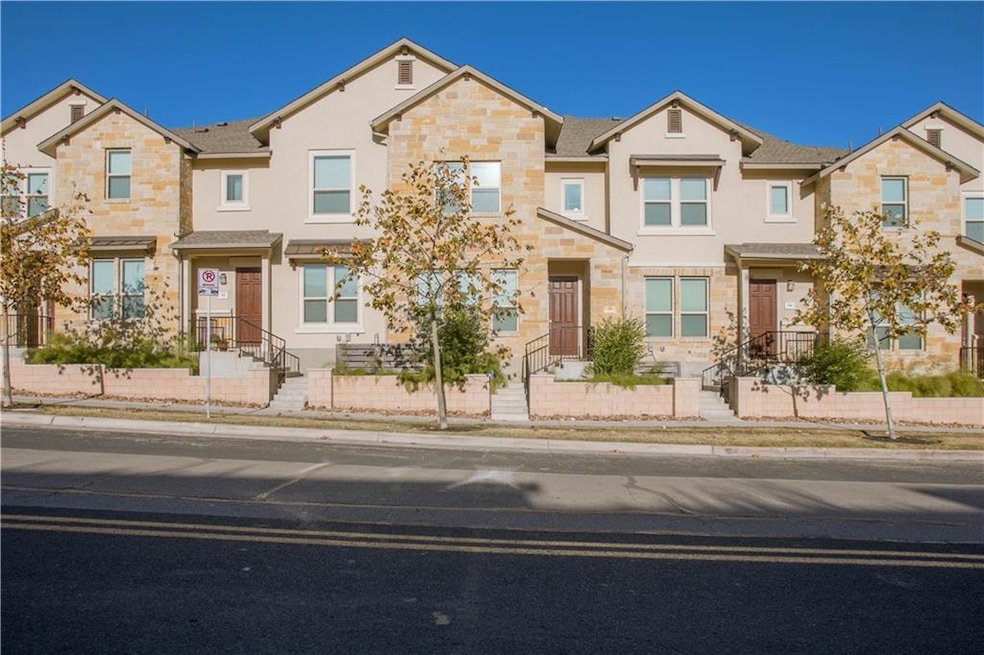 Townhome / multi-family property featuring stone 