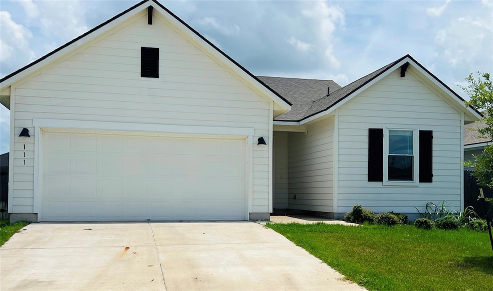 Ranch-style home featuring driveway, an attached 