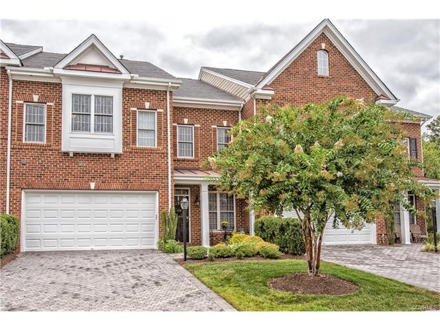 Brick sided home with double width brick paver dri