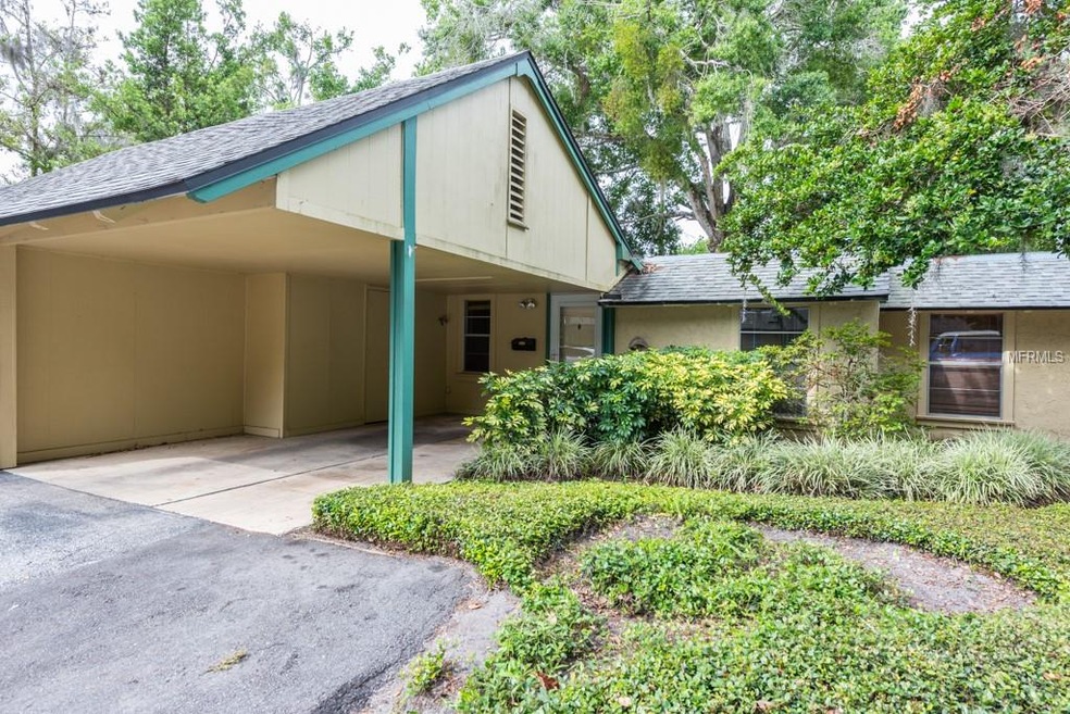 Entrance with a carport (has attic space and outsi