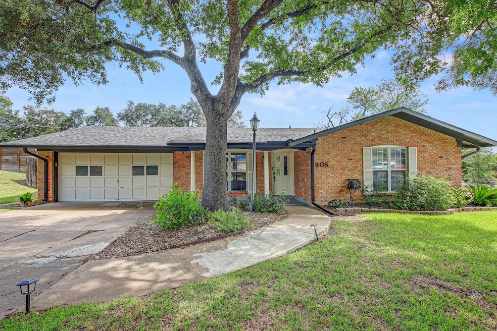 Ranch-style home with brick siding, concrete driv