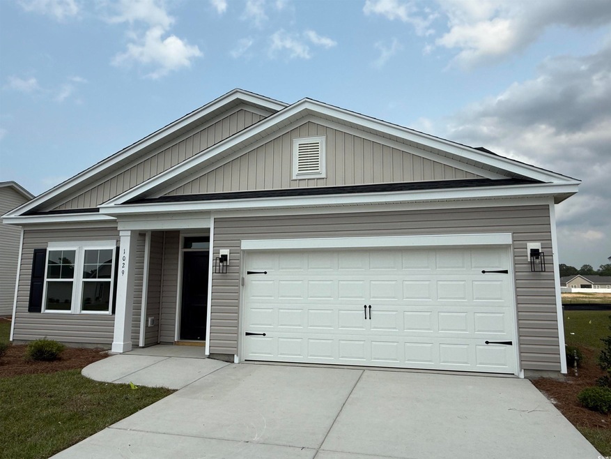Ranch-style house featuring concrete driveway and an attached garage