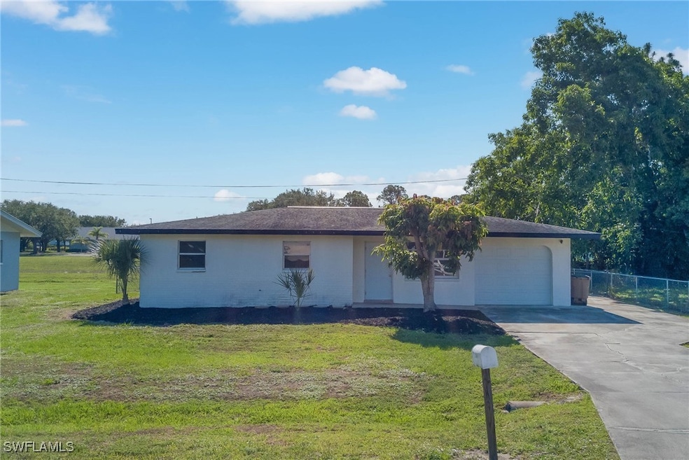 Single story home featuring driveway, an attached