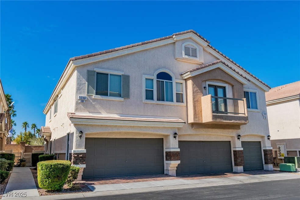View of front of property with a garage, a balcony
