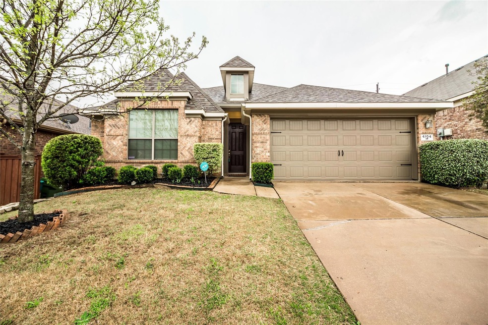 View of front of home featuring a garage and a front lawn