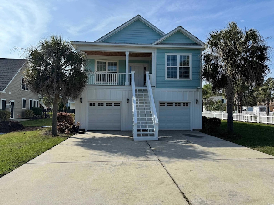 Coastal inspired home with stairs, concrete drivew