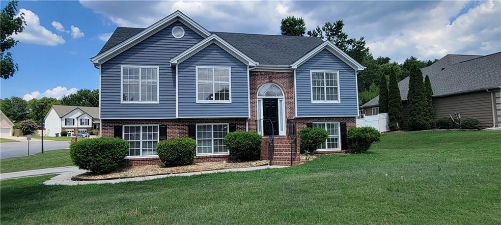 Raised ranch featuring a front yard