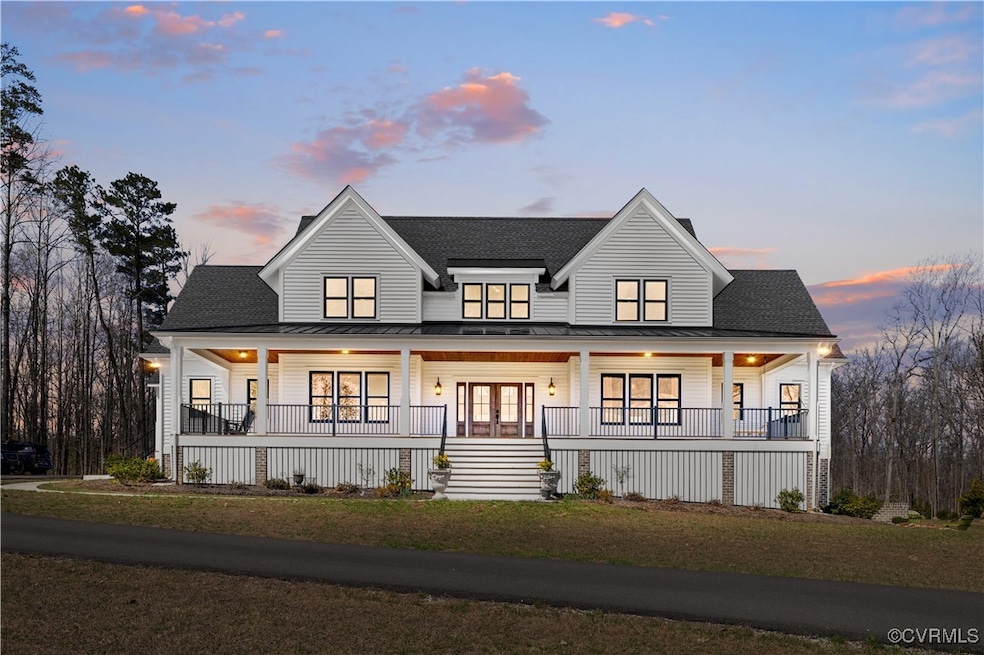 Modern farmhouse with a porch, a standing seam roof, roof with shingles, and metal roof
