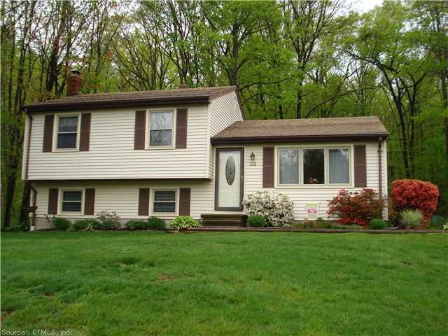 Exterior Front. Nestled on a rolling hill at the e