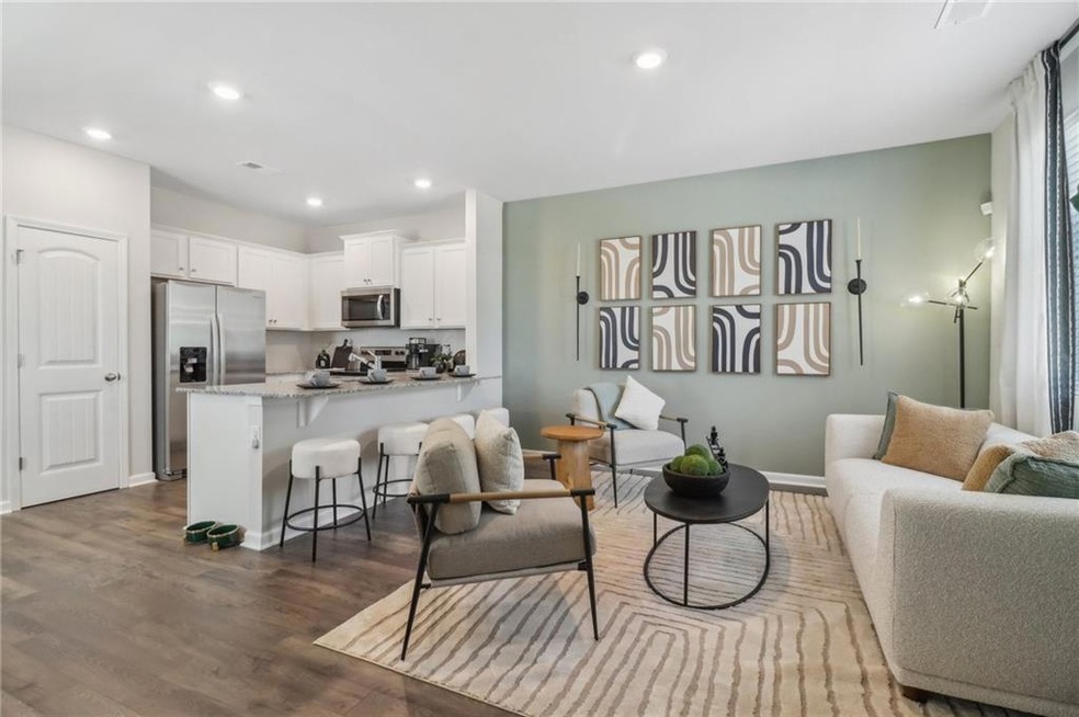 Living room featuring dark wood-style flooring, recessed lighting, and baseboards