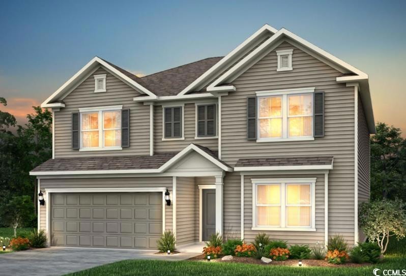 View of front of house featuring a garage, drivewa