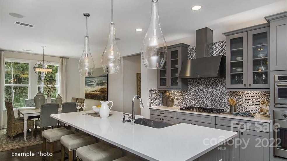 Kitchen opens to great room with large island.  