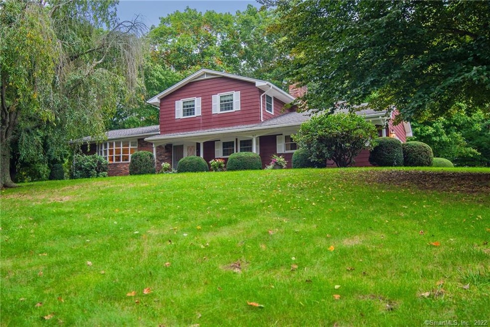 Front of house with long gently sloping hill with 