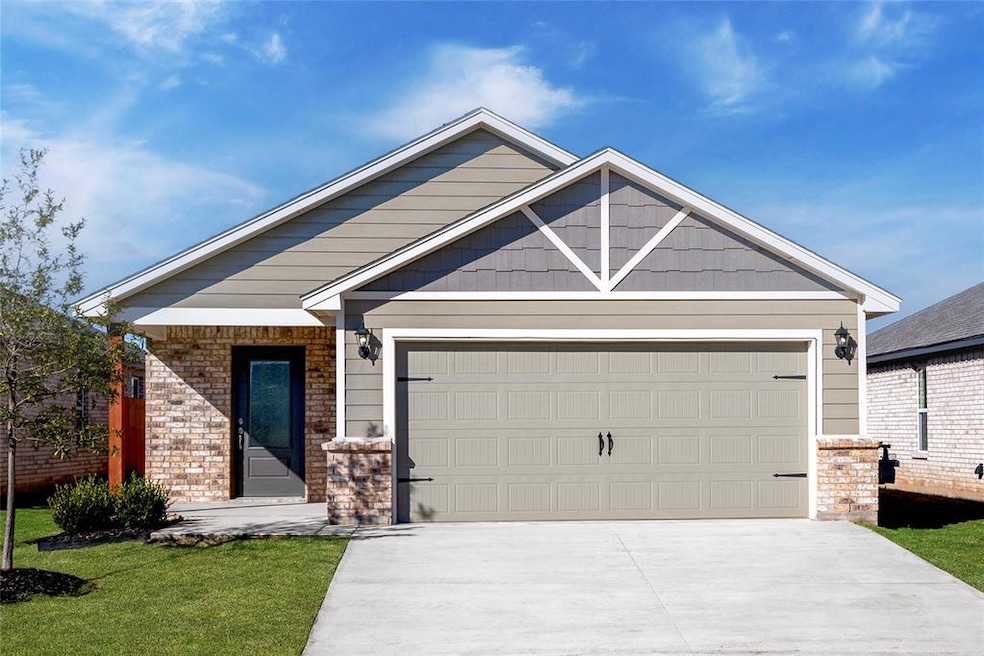 Charming curb appeal with brick and siding accents, a covered entry, and a spacious 2-car garage.