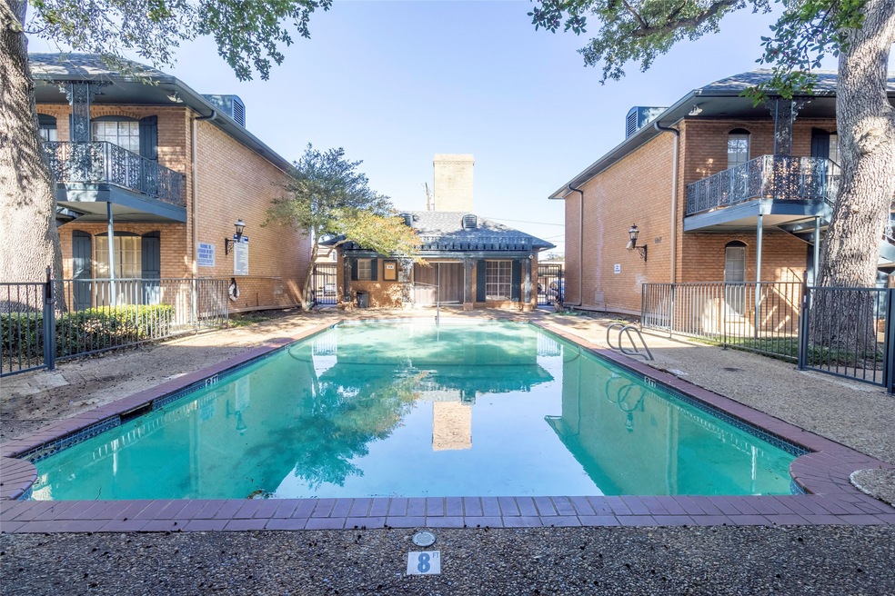 Community pool featuring a patio area and a balcony
