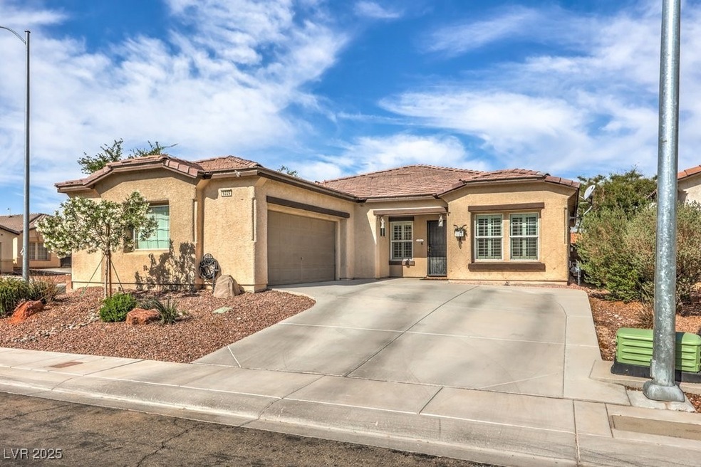 View of front of property featuring a garage, a ti