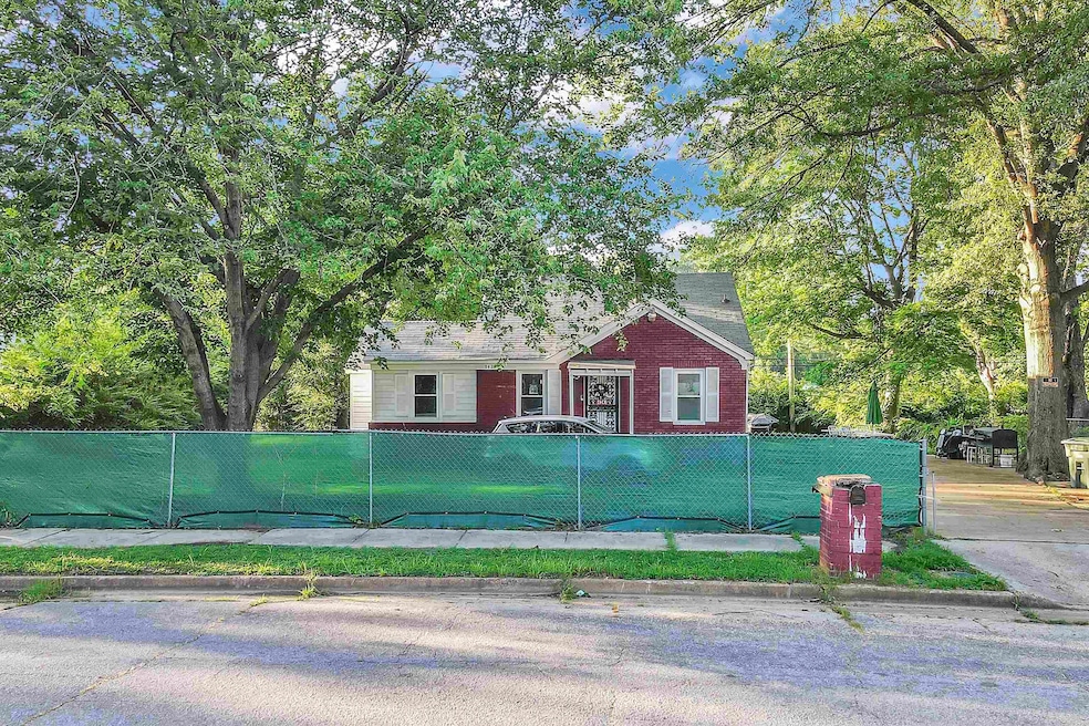 View of front of property with a fenced front yard and brick siding